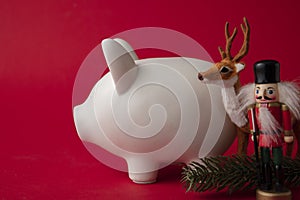 Festive financial savings concept. Piggy bank with Christmas decorations