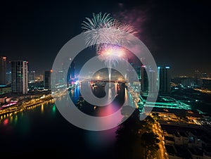 Festive fireworks in the city, the city embankment reflects the festive lights.