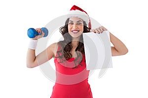 Festive fit brunette showing page and dumbbell