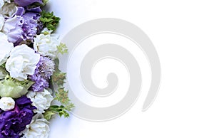 Festive floral arrangement in soft pastel colors. White and purple flowers on a white background. Irises and carnations in a luxur