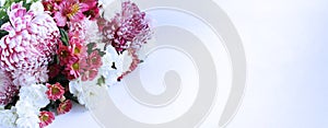 Festive floral arrangement in soft pastel colors. White and purple flowers on a white background.