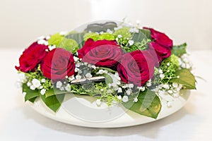 Festive floral arrangements of red roses.