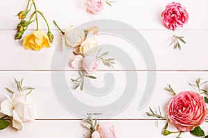 Festive flower composition on the white wooden background. Overh