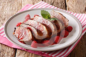 Festive food: sliced grilled duck breast with raspberry sauce an