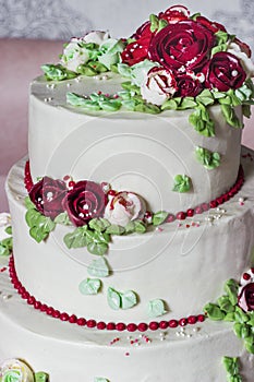 Festive four-level white elegant cake with cream flowers, wedding cake, cream flowers in the Malaysian technique