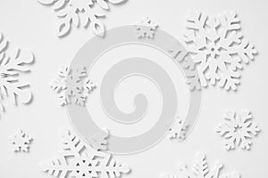 Festive frame made of wooden snowflakes on a white background. Winter, Christmas, New Year concept