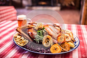 Festive garnished roast duck with apples and red cabbage