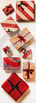 Festive gift boxes in wrapping paper for Christmas, vertical composition