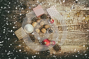 Festive Gifts with Boxes, Baubles, Pine Cones, Walnuts on Wooden Background.