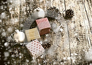 Festive Gifts with Boxes, Baubles, Pine Cones on Wooden Background.