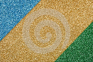 Festive glitter background - abstract geometric composition in golden, green and blue colours with copy space