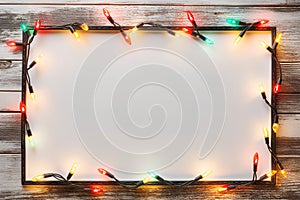 Festive Glow - Christmas Lights Bulb Frame on White Wood, Merry Christmas and New Year Holiday Background. created with Generative