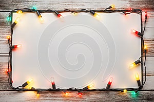 Festive Glow - Christmas Lights Bulb Frame on White Wood, Merry Christmas and New Year Holiday Background. created with Generative