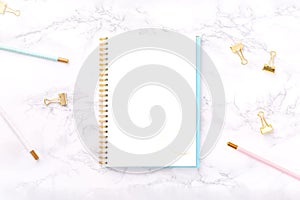 Festive golden stationary on white marble background. Feminine job, gender equality, home office, work from home and