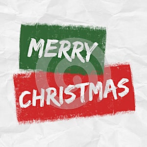 A festive green, red and white MERRY CHRISTMAS graphic illustration with creased paper texture background and grunge elements