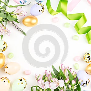 Festive Happy Easter background with decorated eggs, flowers, candy and ribbons in pastel colors on white. Copy space