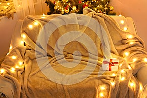 Festive Home interior - wew year or christmas decoration. At night, the room glows with festive lights. A lots of gifts and