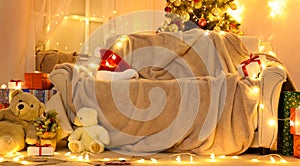 Festive Home interior - wew year or christmas decoration. At night, the room glows with festive lights. A lots of gifts and