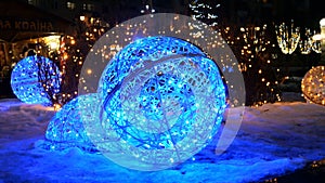 Festive illumination. Ball with artificial blue illuminated inside on night winter street on christmas hollidays.