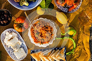 Festive image of Mediterranean Food. Bulgur salad, cheese, olives and lemons