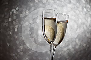 Festive image of two wine glasses with sparkling champagne