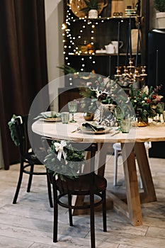 Festive kitchen in Christmas decorations. Christmas dining room. Beautiful New Year decorated classic home interior.
