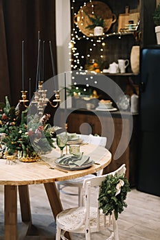 Festive kitchen in Christmas decorations. Christmas dining room. Beautiful New Year decorated classic home interior.