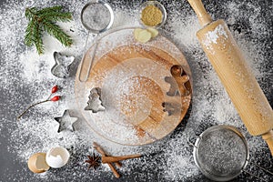 Festive kitchen flour background for making christmas gingerbread cookies with cutters and decor