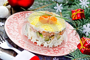 Festive layered salad with salmon avocado rice and egg , beautiful salad for the holiday christmas