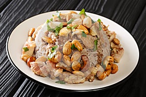 Festive Lebanese dish Riz bi-Djaj rice with cinnamon  chicken and nuts close-up in a plate. horizontal