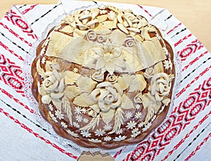 Festive loaf of bread, decorated with flowers from a dough