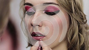 Festive makeup artist contouring woman lips liner