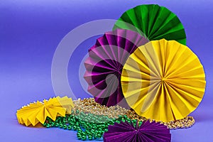 Festive Mardi Gras masquerade violet background. Fat Tuesday carnival, masks, beads, traditional decor