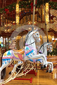 Festive merry-go-round carousel with horses and lights in Frankfurt during the Christmas market, Christmas holiday