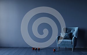 Festive monochrome interior in dark blue with a velour armchair