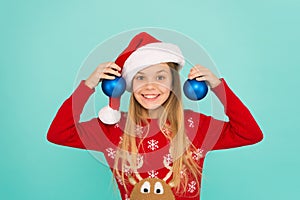 Festive mood. Decorative accessories. Decorating christmas tree. Girl smiling face hold balls blue background. Let kid