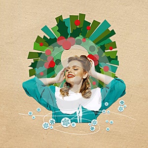 Festive mood. Happy, beautiful woman in elegant dress over beige background with Christmas wreath. Contemporary art
