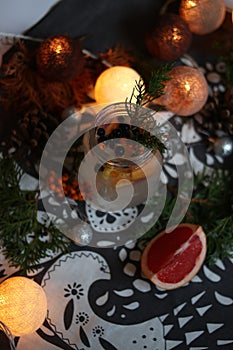festive mulled wine with berries, glowing garlands, cozy Christmas atmosphere