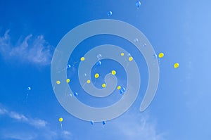 Festive multi-colored balloons in the blue sky