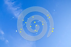 Festive multi-colored balloons in the blue sky