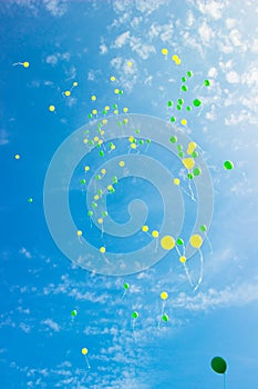 Festive multi-colored balloons in the blue sky