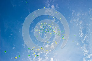 Festive multi-colored balloons in the blue sky