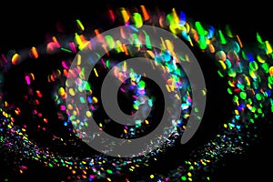 Festive neon lights swirl of flares isolated on black background