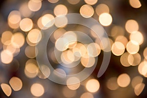 Festive New-year background with bokeh from Christmas tree lights glowing. Blurred colorful circles on light holiday