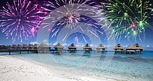 Festive New Year fireworks over the tropical island, mixed media