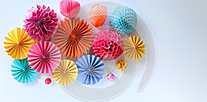 Festive Paper Decorations Array variety of shapes, colors and textures on a light background