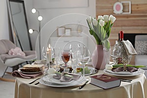 Festive Passover table setting with Torah at home.