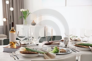 Festive Passover table setting with Torah at home.