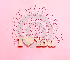 Festive pink background with spangles in the shape of heart. n