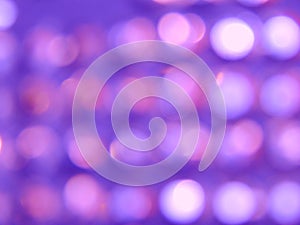 Abstract violet bokeh lights background texture.